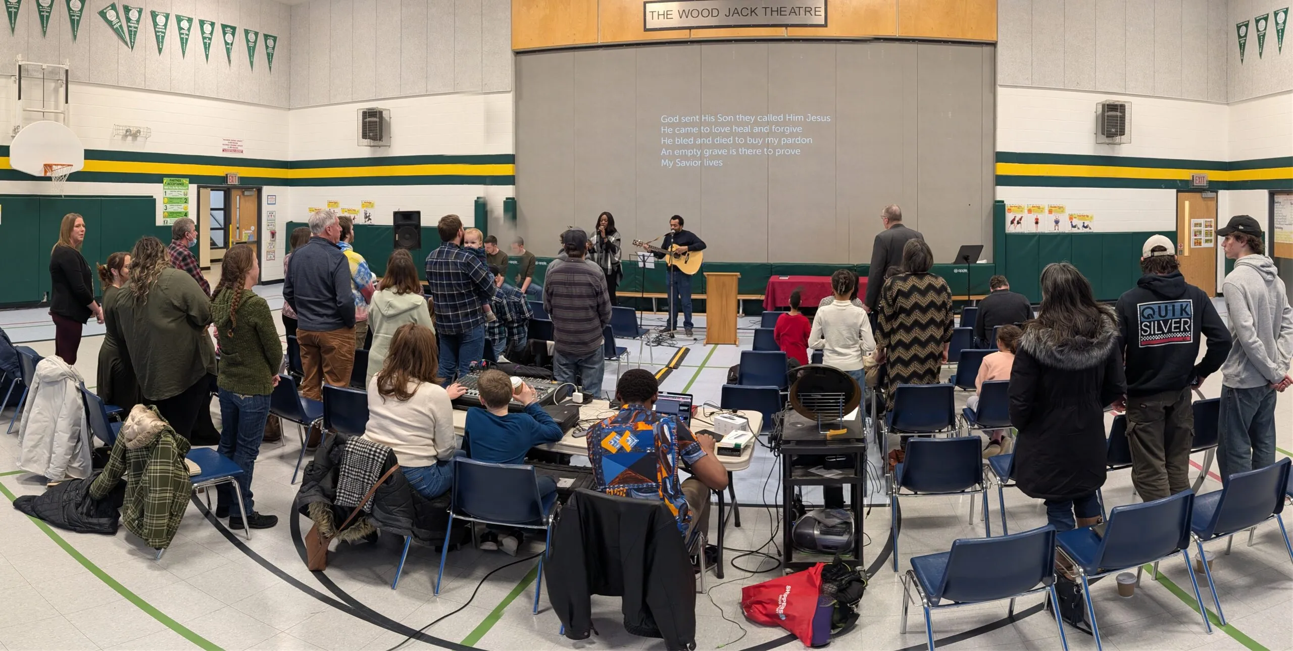The Village Church gathering for Sunday worship in the school gym